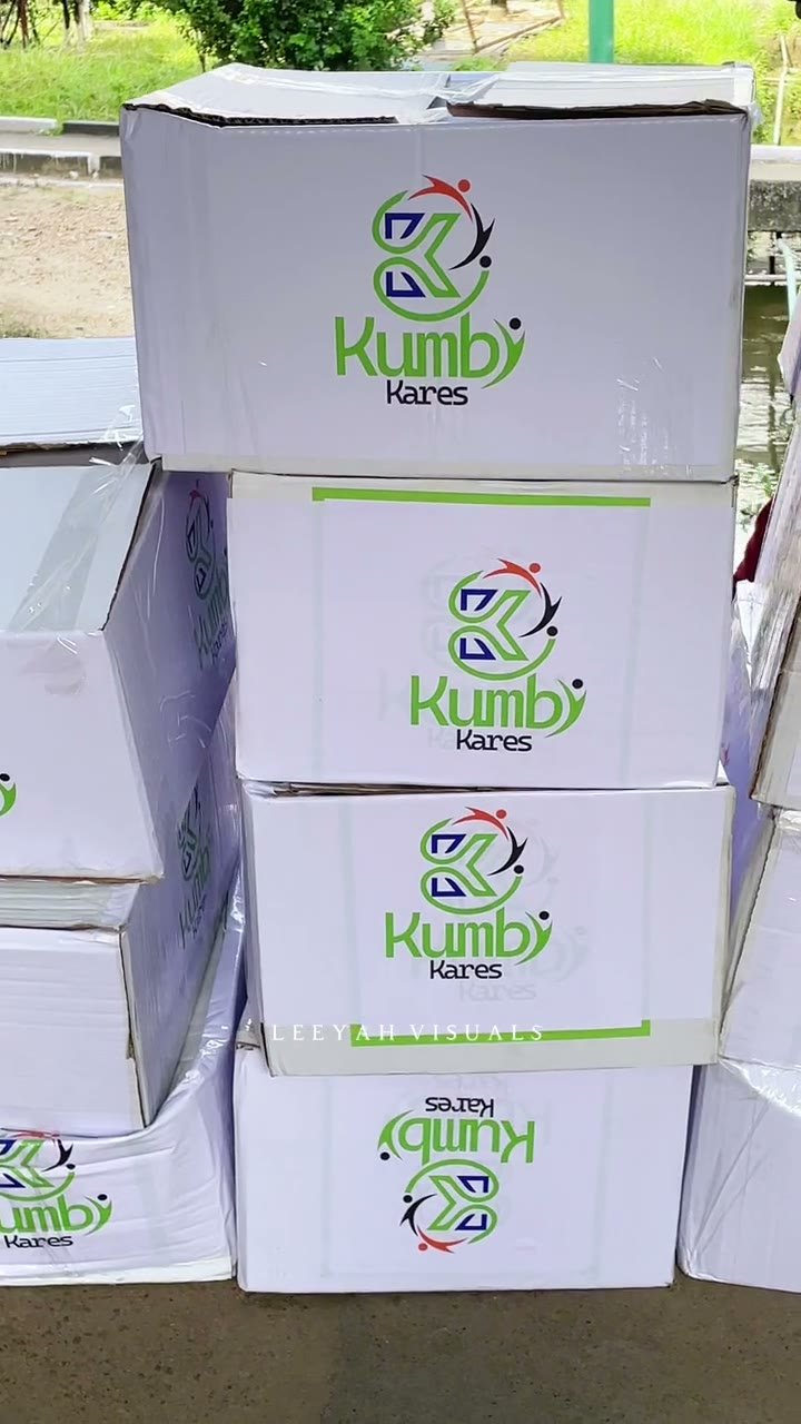 Kunbi Kares team member with stacked donated care packages