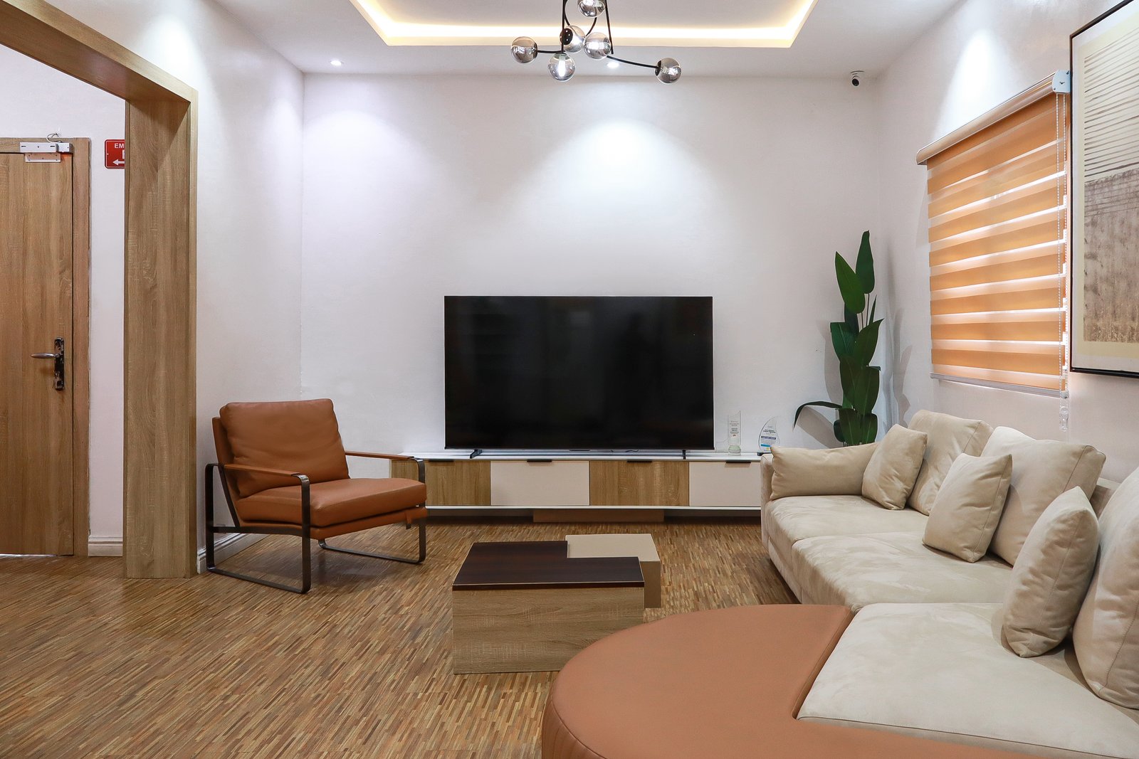Executive reception lounge with sofa seating and media wall