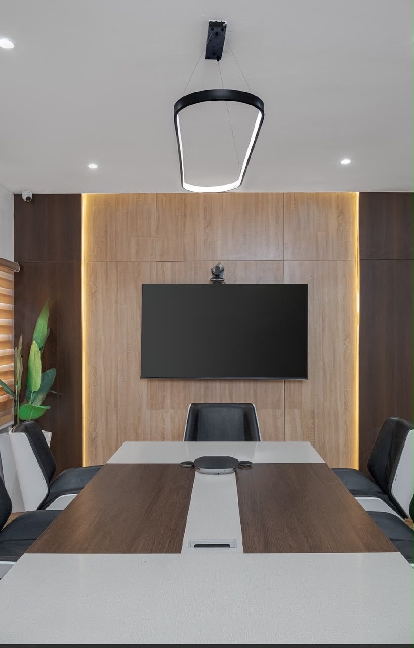 Boardroom with wood-panelled media wall and mounted screen