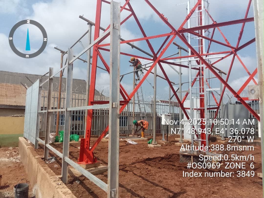 Workers erecting the steel tower structure